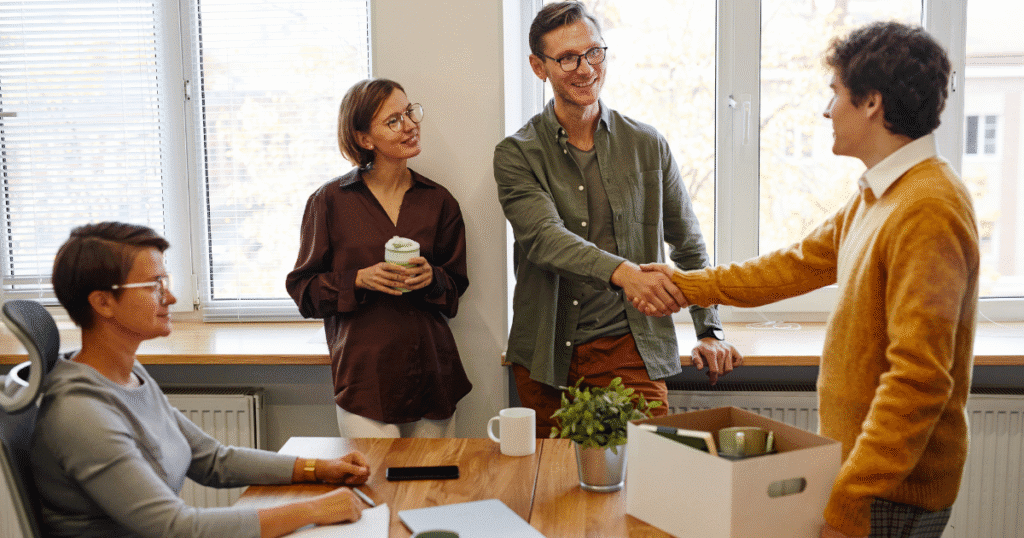 Coworkers discussing employee relocation policies in a modern office environment.