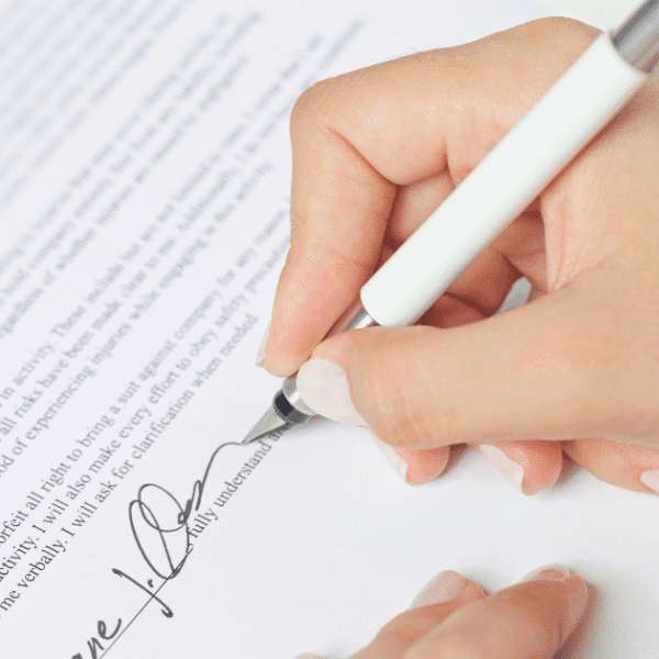 Employer signing legal employment contract with non-solicitation clauses for workforce protection.