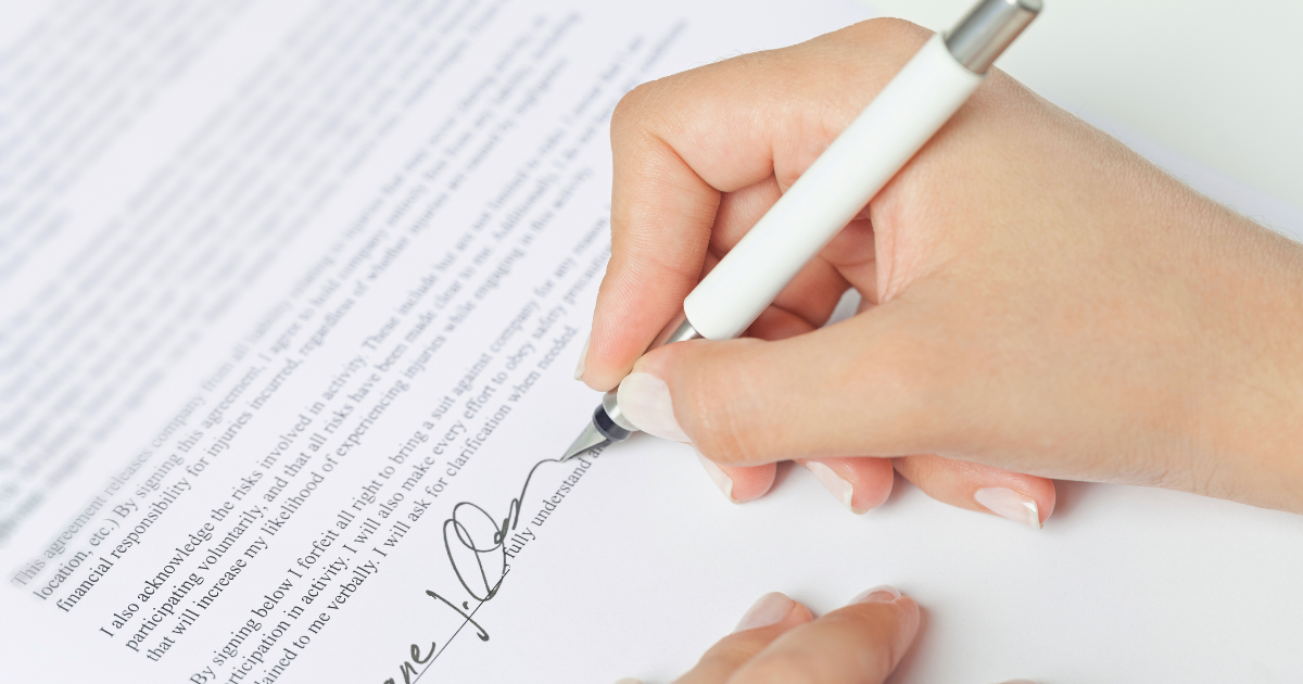 Employer signing legal employment contract with non-solicitation clauses for workforce protection.