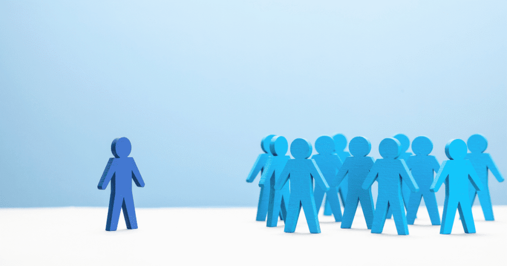 A lone blue figure stands apart from a group, symbolizing false discrimination claims at work.