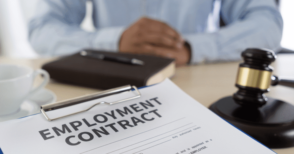 Attorney reviewing workplace legal contracts with arbitration clauses in employment agreements.