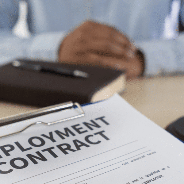 Attorney reviewing workplace legal contracts with arbitration clauses in employment agreements.